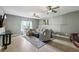 Open living area with neutral decor, large windows, and comfortable seating at 8385 E Village School E Dr, Cumming, GA 30041
