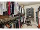 Organized walk-in closet features shelving and hanging racks for clothing storage at 8385 E Village School E Dr, Cumming, GA 30041