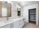 Bathroom featuring double sinks, a vanity, and walk in closet at 1080 Peachtree Ne St # 1504, Atlanta, GA 30309