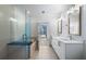 Bathroom featuring double sinks, a vanity, a glass shower and balcony access at 1080 Peachtree Ne St # 1504, Atlanta, GA 30309
