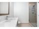 Bathroom features vanity with white marble countertop and modern fixtures with glass shower at 1080 Peachtree Ne St # 1504, Atlanta, GA 30309