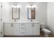 Bathroom features double sink vanity with modern fixtures and toilet with white cabinets at 1080 Peachtree Ne St # 1504, Atlanta, GA 30309