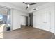 Well-lit bedroom features hardwood floors, a ceiling fan, and access to outdoor balcony at 1080 Peachtree Ne St # 1504, Atlanta, GA 30309