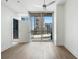 Open bedroom with a ceiling fan, hardwood floors, balcony access and great city views at 1080 Peachtree Ne St # 1504, Atlanta, GA 30309