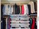Customized walk-in closet with shelving and hanging rods for clothes and accessories at 1080 Peachtree Ne St # 1504, Atlanta, GA 30309
