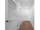 Bright hallway features hardwood floors, white doors and baseboards, and recessed lighting at 1080 Peachtree Ne St # 1504, Atlanta, GA 30309