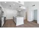 Well-lit kitchen featuring stainless steel appliances, a kitchen island, and wood floors throughout at 1080 Peachtree Ne St # 1504, Atlanta, GA 30309