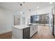 Modern kitchen boasts a center island, stainless appliances and adjacent living area with city views at 1080 Peachtree Ne St # 1504, Atlanta, GA 30309