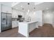 Modern kitchen features stainless steel appliances, white cabinets, and a spacious island with pendant lighting at 1080 Peachtree Ne St # 1504, Atlanta, GA 30309