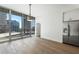 Bright living space featuring stainless steel fridge, hardwood floors, city views, and natural light at 1080 Peachtree Ne St # 1504, Atlanta, GA 30309