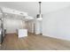Open-concept living space with kitchen and island, hardwood floors, recessed lights and modern pendant light at 1080 Peachtree Ne St # 1504, Atlanta, GA 30309