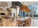 Modern resident lounge with long table, stylish pendant lighting and floor to ceiling windows at 1080 Peachtree Ne St # 1504, Atlanta, GA 30309
