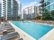 Relaxing pool deck with lounge chairs, umbrellas and views of nearby building at 1080 Peachtree Ne St # 1504, Atlanta, GA 30309