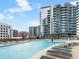 Rooftop pool deck featuring lounge chairs, an in-pool island, and building views at 1080 Peachtree Ne St # 1504, Atlanta, GA 30309