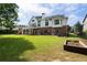 Landscaped backyard showcases a large lawn, outdoor fireplace, and a private hot tub for relaxation at 1127 Bank Se St, Smyrna, GA 30080