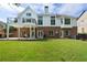 Expansive backyard featuring a well-manicured lawn, brick patio, and deck ideal for outdoor gatherings at 1127 Bank Se St, Smyrna, GA 30080