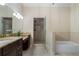 Bright bathroom with granite countertops, double sinks, and walk-in shower and tub at 1127 Bank Se St, Smyrna, GA 30080