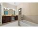 A bright bathroom with a double vanity, granite countertops and a separate bathtub at 1127 Bank Se St, Smyrna, GA 30080