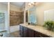 A serene bathroom featuring a granite countertop, dark cabinets, and a bathtub with stone tile surround at 1127 Bank Se St, Smyrna, GA 30080