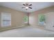 Large bedroom with ceiling fan, three windows, neutral walls and carpet at 1127 Bank Se St, Smyrna, GA 30080