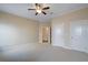 Large bedroom with ceiling fan and plush carpet; ensuite bathroom entrance at 1127 Bank Se St, Smyrna, GA 30080