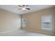 Spacious bedroom with neutral walls and carpet, ceiling fan and two windows at 1127 Bank Se St, Smyrna, GA 30080