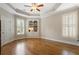 Bedroom features hardwood floors, a ceiling fan, and large windows with built-in bookcase at 1127 Bank Se St, Smyrna, GA 30080