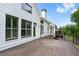 Side view of the outdoor wooden deck featuring white siding and trimmed windows at 1127 Bank Se St, Smyrna, GA 30080