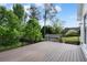 View of the wooden deck, metal railings, and backyard with mature trees at 1127 Bank Se St, Smyrna, GA 30080