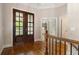 Entryway featuring hardwood floors, elegant double doors, and views into adjacent rooms at 1127 Bank Se St, Smyrna, GA 30080