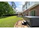 Backyard view with a hot tub, stone walkway, outdoor fireplace and patio area for entertaining at 1127 Bank Se St, Smyrna, GA 30080