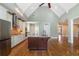 Kitchen area with a large island, modern appliances, and vaulted ceiling with white beams at 1127 Bank Se St, Smyrna, GA 30080