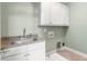Laundry room with white cabinets and granite countertops at 1127 Bank Se St, Smyrna, GA 30080