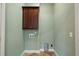 Functional laundry room with overhead cabinet and tile flooring at 1127 Bank Se St, Smyrna, GA 30080
