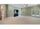 Spacious living room with a ceiling fan, neutral carpet, and door to outdoor patio at 1127 Bank Se St, Smyrna, GA 30080