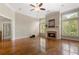 Inviting living room features a fireplace, hardwood floors, and large windows with shuttered blinds at 1127 Bank Se St, Smyrna, GA 30080