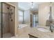 Bright main bathroom featuring granite countertop, double vanity, tiled shower, and large soaking tub at 1127 Bank Se St, Smyrna, GA 30080