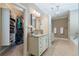 Beautiful main bathroom with double vanity, tiled floor, chandelier, and walk-in closet with custom shelving at 1127 Bank Se St, Smyrna, GA 30080