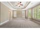 Spacious main bedroom with tray ceiling, ceiling fan, neutral walls, and large windows with plantation shutters at 1127 Bank Se St, Smyrna, GA 30080