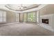 Main bedroom with plush carpet, fireplace, and large windows with plantation shutters at 1127 Bank Se St, Smyrna, GA 30080