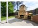 Outdoor stone fireplace on a patio with seating at 1127 Bank Se St, Smyrna, GA 30080