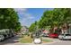 Tree-lined street with parked cars, sidewalks, and commercial buildings, offering a vibrant urban setting at 1127 Bank Se St, Smyrna, GA 30080