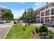 Street view of a commercial district lined with shops and restaurants, with street lamps and greenery at 1127 Bank Se St, Smyrna, GA 30080