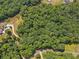 Expansive aerial view of a lush, tree-covered lot with winding roads and scattered residences at 146 Sherwood Ln, Canton, GA 30115