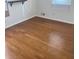 Empty bedroom with hardwood flooring, freshly painted and light from window at 4149 Silver Hill Ct, Snellville, GA 30039
