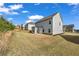 Back view of two-story home with vinyl siding and a small patio at 5140 Woodline View Cir, Auburn, GA 30011