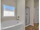 Bathroom features soaking tub, shower, and tile flooring at 5140 Woodline View Cir, Auburn, GA 30011