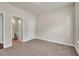 Bedroom with neutral walls and carpet, with view of an ensuite bathroom at 5140 Woodline View Cir, Auburn, GA 30011