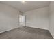 Neutral bedroom with carpet floors and doorway to another room at 5140 Woodline View Cir, Auburn, GA 30011