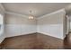 Spacious dining room featuring hardwood floors, decorative wall trim, and large windows at 5140 Woodline View Cir, Auburn, GA 30011